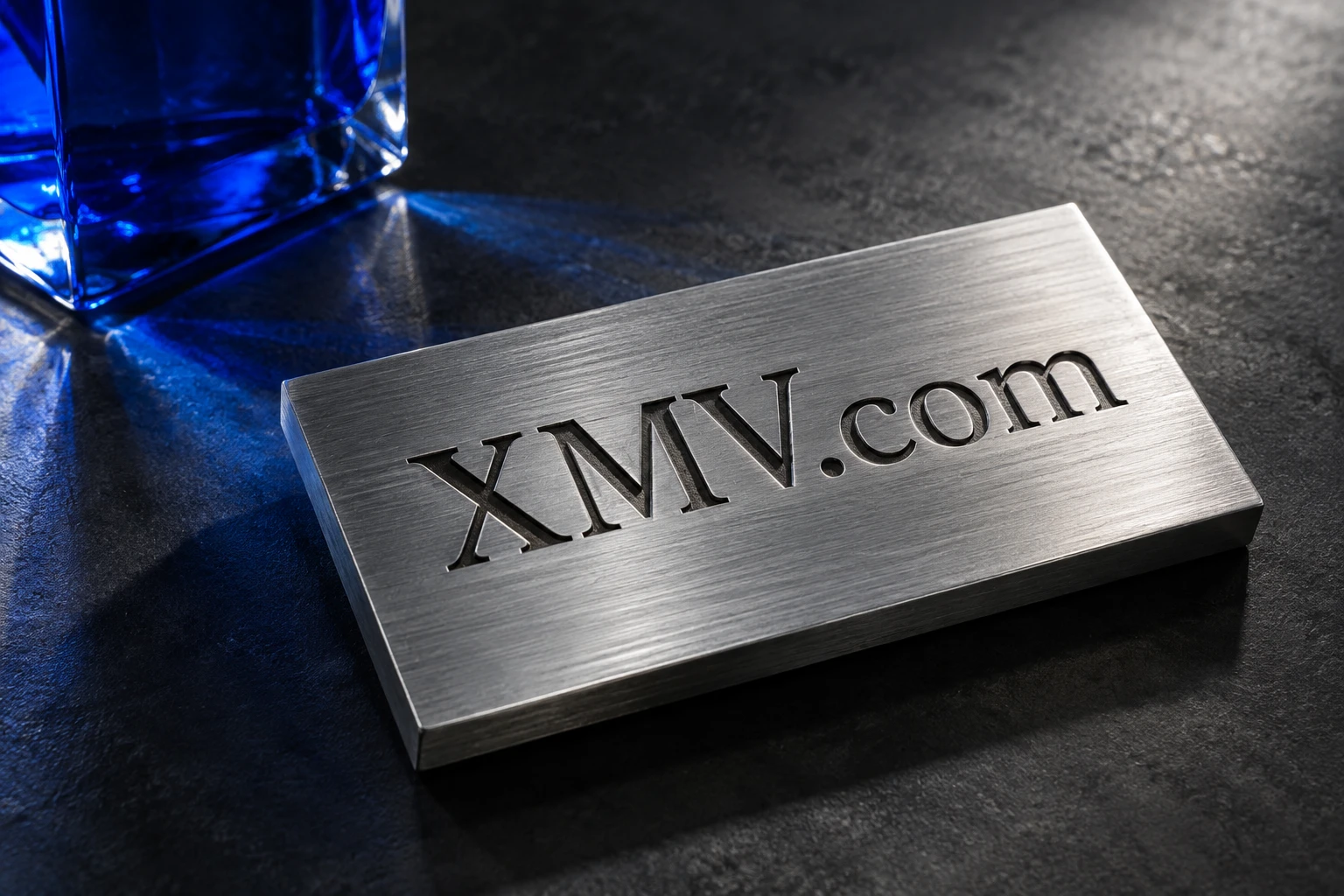 XMV.com engraved on a brushed aluminum plaque